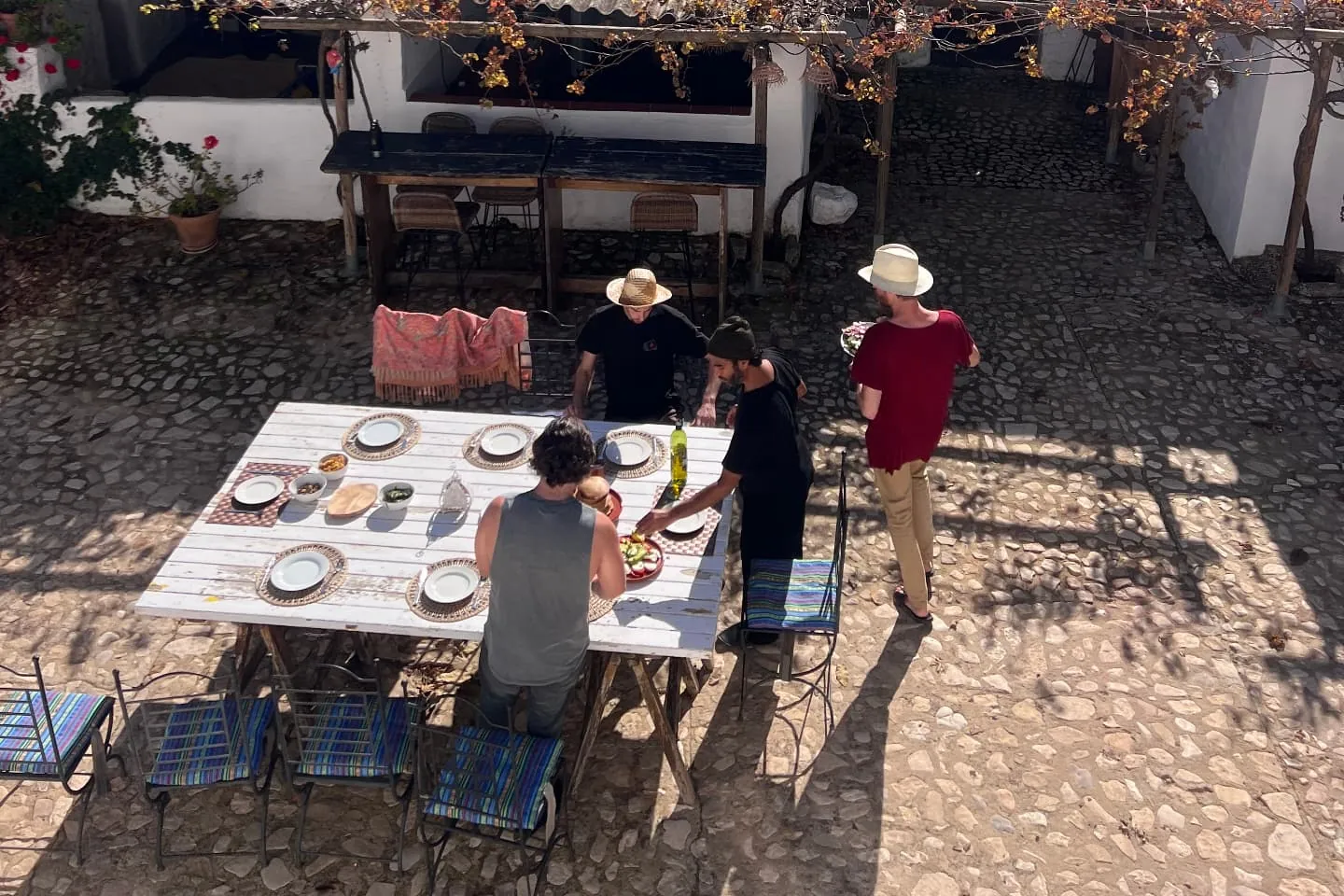 Brothers setting the table in the courtyard