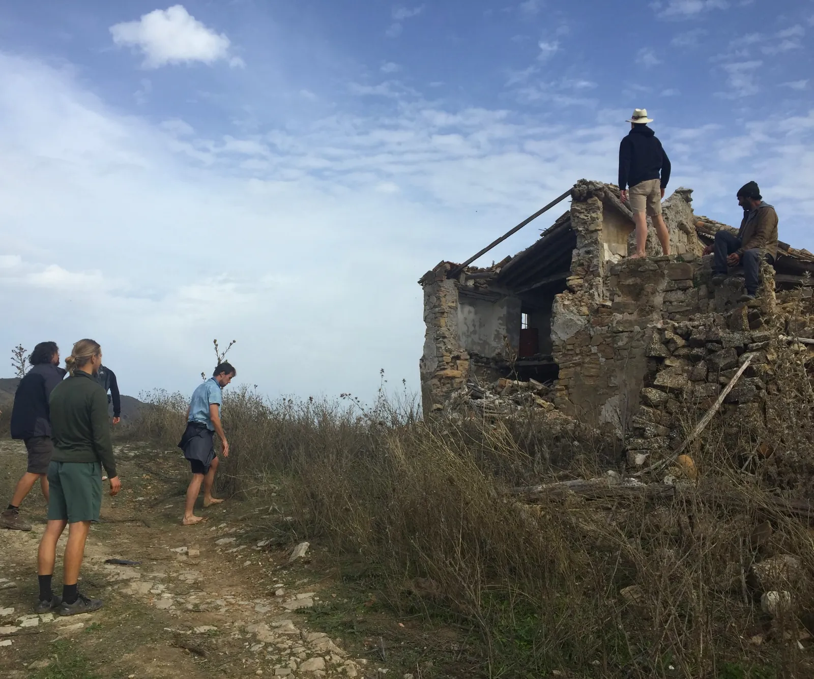 Brothers exploring an old stone ruin on a hilltop