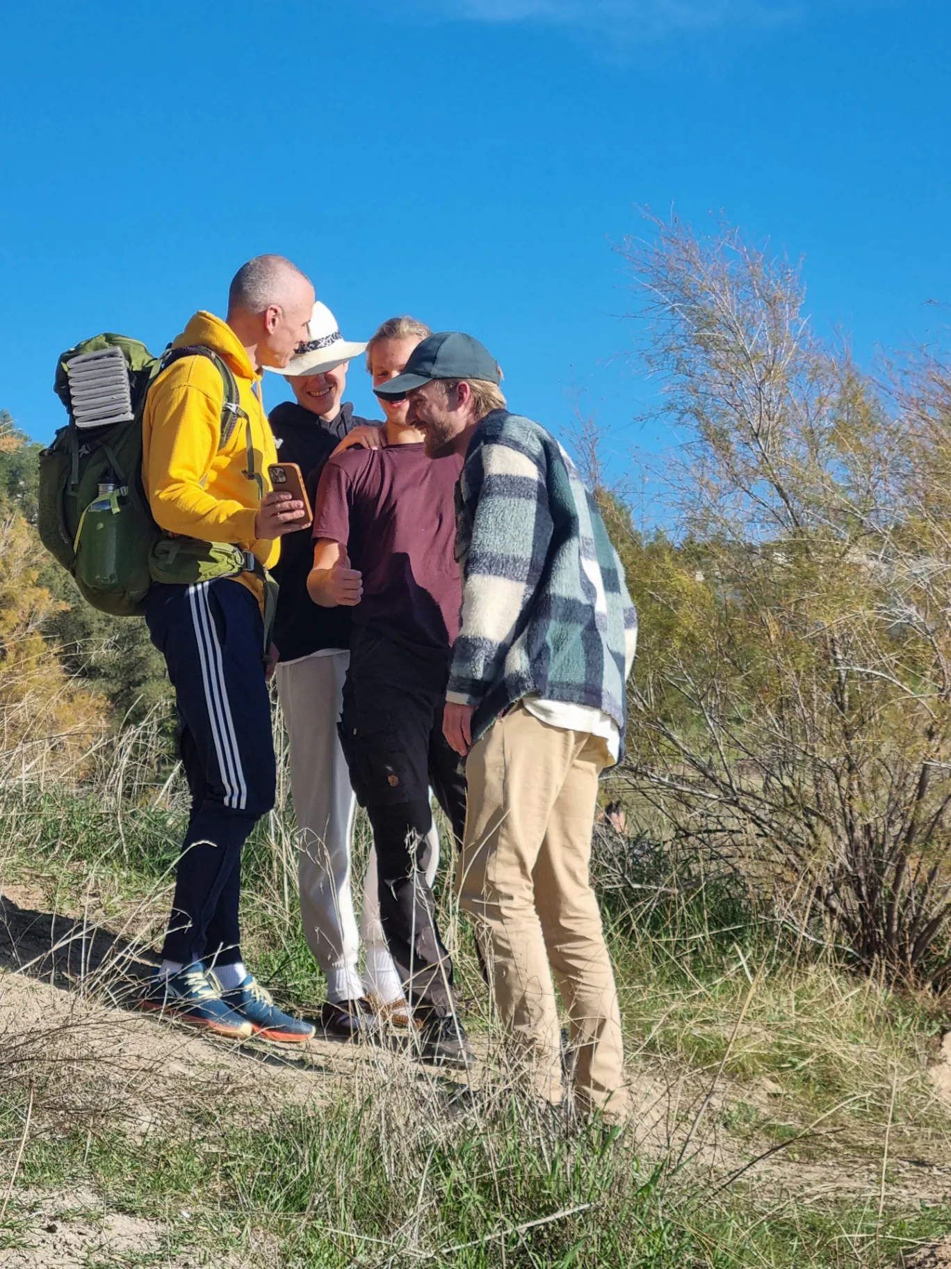 A circle of men on a hike, sharing a moment